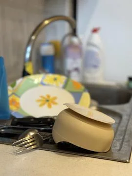 Clean Dishes Drying on Kitchen Counter Near Sink Stock Photos