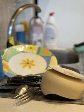 Clean Dishes Drying on Kitchen Counter Near Sink Stock Photos