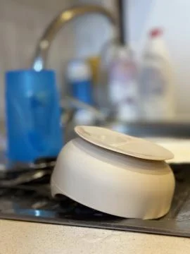 Clean Dishes Drying on Kitchen Counter Near Sink 写真素材