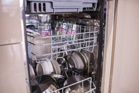 Clean Dishes Ready for Use With Glasses and Pots in a Modern Dishwasher in a Stock Photos