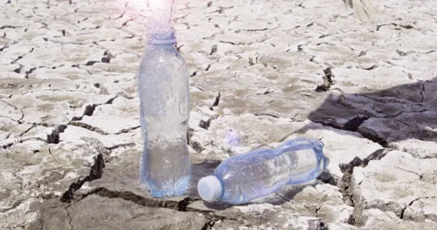 Clean drinking water is pouring into plastic bottle cracked ground, Looping Stock Footage 147198166