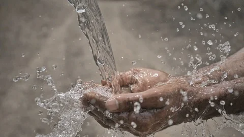 Clean drinking water splashing on hands of the Indian farmer in India Stock Footage 90063316