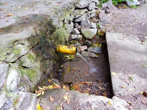 Clean drinking water spring flows from the pipe Stock Photos