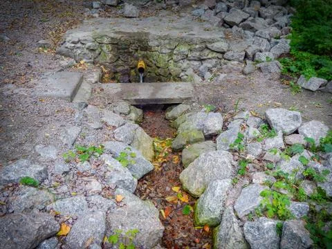 Clean drinking water spring flows from the pipe Stock Photos