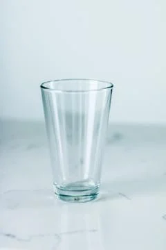 Clean empty glass on marble table Stock Photos