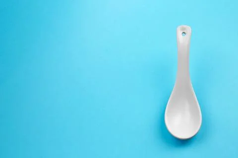 Clean empty miso spoon on blue background, space for text Stock Photos