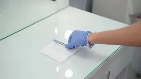 On a clean, empty surface of the table, the browist lays out his instrument. Stock Footage 144639847