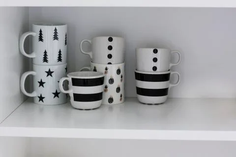 Clean empty white mugs on the shelf Stock Photos