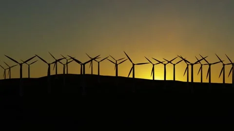 Clean energy: Large farm of wind turbines on a hill at sunset Stock Footage