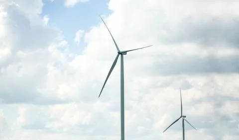 Clean energy power concept, wind turbine and cloud sky. Stock Photos