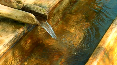 Clean, fresh, natural spring of drinking water with wooden channel Stock Footage 63355510