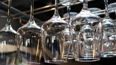 Clean glasses hang upside down over the bar counter in a restaurant. Stock Footage 272336723