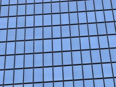 Clean grid pattern of glass window panels with thin black frames reflecting sky Stock Photos