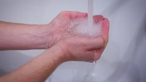 Clean Hands Under Water Stream on White Background Video stock 334840659