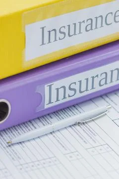 Clean insurance form, colored folders and a pen Stock-Fotos