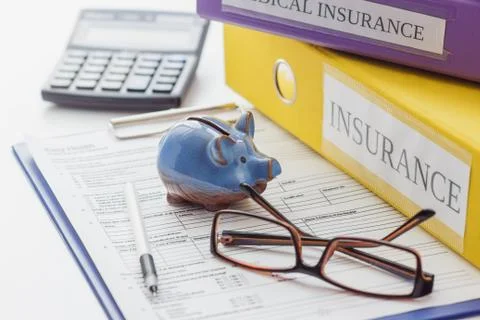 Clean insurance form, folders, pen, piggy bank, glasses and calculator Stock Photos