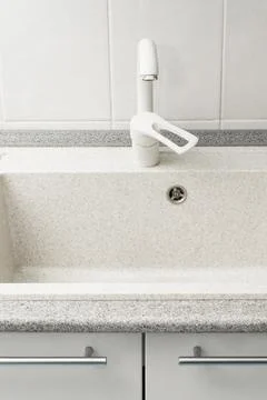Clean kitchen sink. Bright kitchen with free dishwasher. Stock Photos