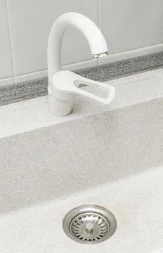 Clean kitchen sink. Bright kitchen with free dishwasher. Stock Photos