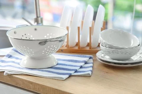 Clean kitchenware drying on wooden countertop Stock Photos