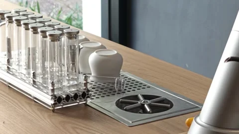 Clean lab and kitchen equipment arranged on wooden countertop near window Stock Footage 344746747