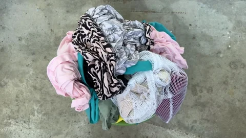 Clean laundry after washing on concrete floor, colorful wet clothes  Stock Footage 345327212