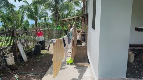 Clean laundry hands on clotheslines in backyard of cottage Stock Footage 308917202