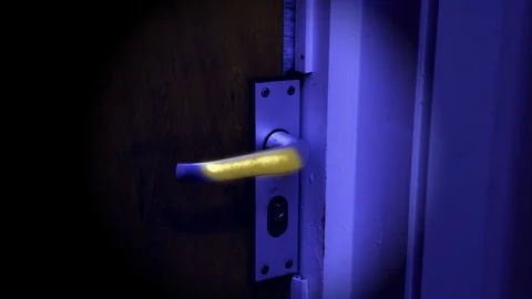 Clean looking door handle under blacklight reveals invisible germs Stock Footage 128205196