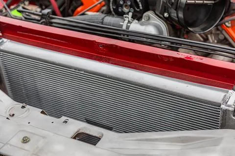 Clean metallic intercooler in vehicle engine bay Foto stock