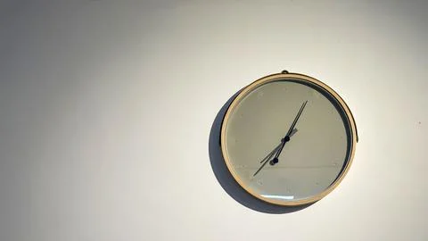 Clean modern clock hanging on the wall Stock Photos
