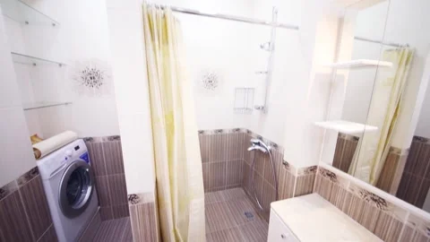 Clean modern empty bathroom with bath and washing machine Stock Footage 276359038
