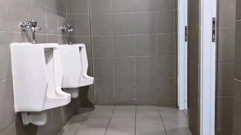 Clean modern empty men public restroom toilet corner interior featuring whi.. Stock Footage 341827070