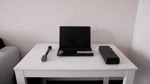 Clean modern workspace with black laptop, mouse, and tools on glossy white de Stock Photos