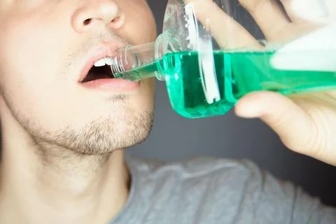 Clean mouth with fluid mouthwash to prevent bad smell and get fresh breath Stock Photos