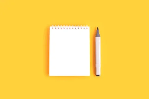 Clean notepad mockup and felt tip pen on a yellow background. Stock Photos