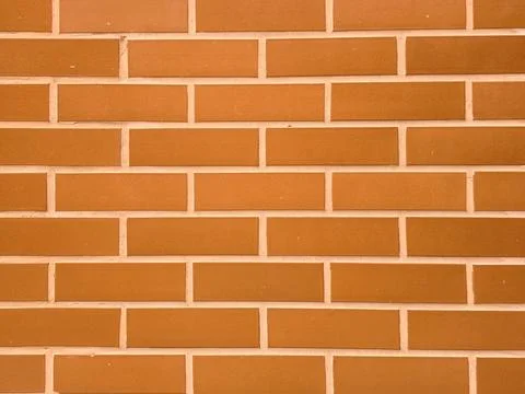 Clean orange brick wall texture background with regular pattern Stock Photos