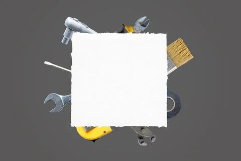 Clean paper surrounded by tools: brush, pliers, screwdriver, tape measure Stock Photos
