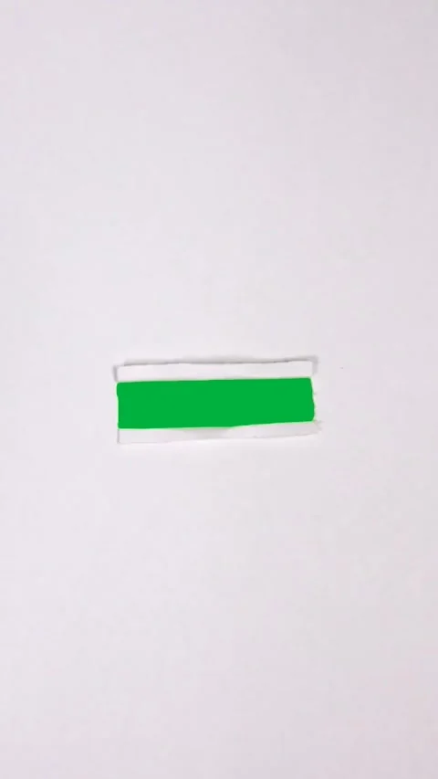 A clean piece of paper folded slightly and then crumpled on a green. Stock Footage 306846878