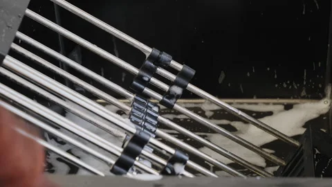Clean plastic rack with metal bars drains in kitchen sink Stock Footage 316172349