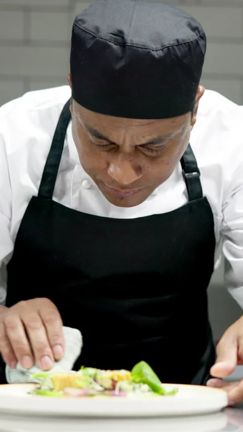 Clean plate, man and chef in restaurant kitchen, fine dining and commitment to Stock Footage 327360507