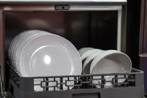 Clean plates in dishwasher machine Stock Photos