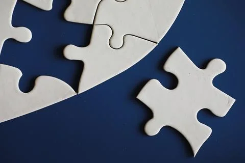 Clean puzzle elements on the background. Empty puzzle piece on the table. T.. Stock Photos