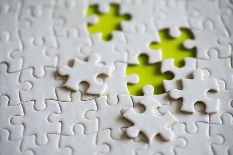 Clean puzzle elements on the background. Empty puzzle piece on the table. T.. Stock Photos