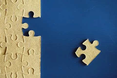 Clean puzzle elements on the background. Empty puzzle piece on the table. T.. Stock Photos