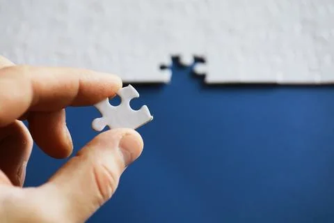Clean puzzle elements on the background. Empty puzzle piece on the table. T.. Stock Photos