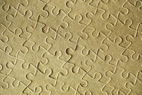 Clean puzzle elements on the background. Empty puzzle piece on the table. T.. Stock Photos