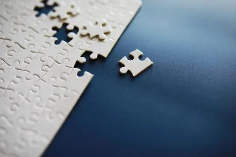 Clean puzzle elements on the background. Empty puzzle piece on the table. T.. Stock Photos