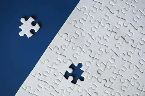 Clean puzzle elements on the background. Empty puzzle piece on the table. T.. 스톡 사진