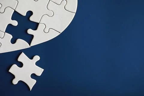 Clean puzzle elements on the background. Empty puzzle piece on the table. T.. Stock Photos