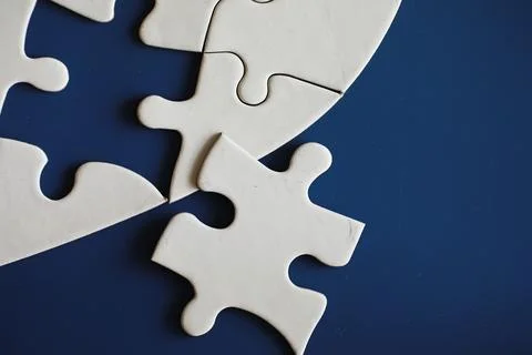 Clean puzzle elements on the background. Empty puzzle piece on the table. T.. Stock Photos