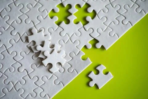 Clean puzzle elements on the background. Empty puzzle piece on the table. T.. Stock Photos